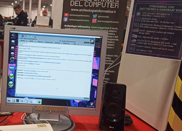 a picture showing the homepage of this website, though with missing colors, running on a computer clearly labeled as a custom made Amiga